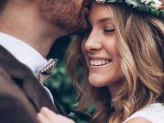 A groom hugging and kissing his bride