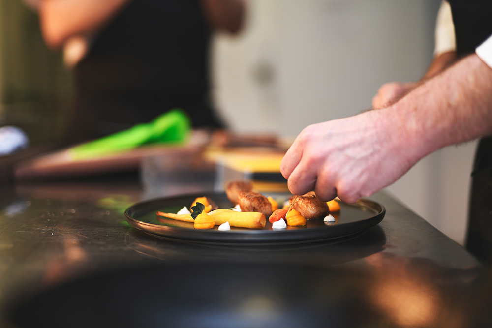 A chef preparing a plat of fine dining