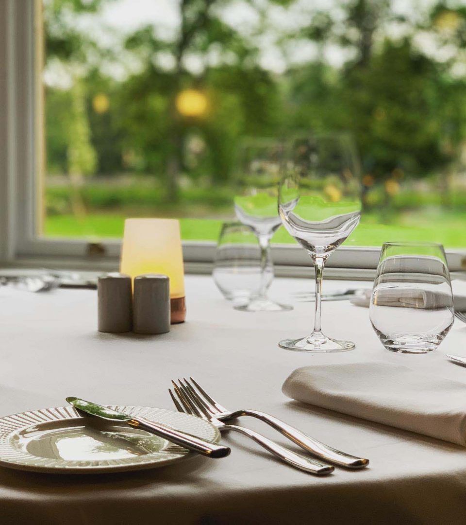 table set with view out to gardens