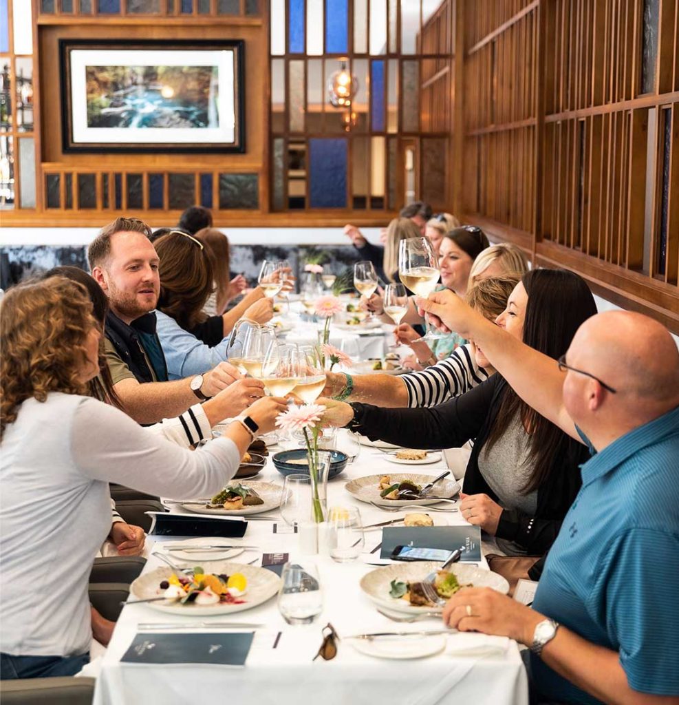 Group of diners toasting to their dinner