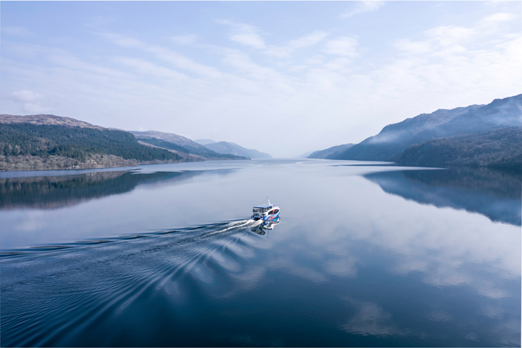 A boat travelling across Loch Ness in Scotland