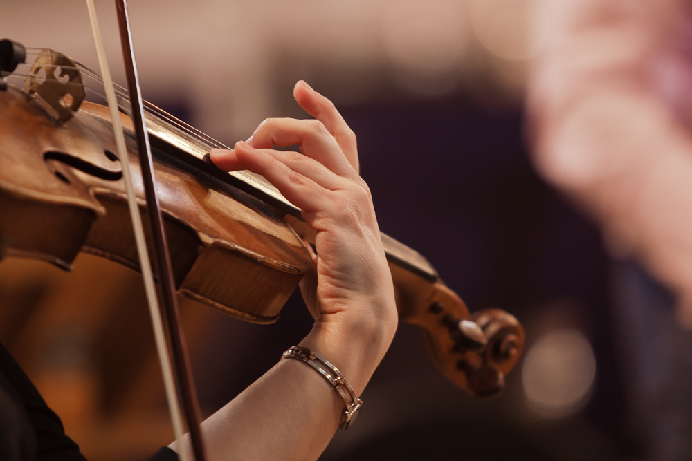 Close up of hand and bow on a violin