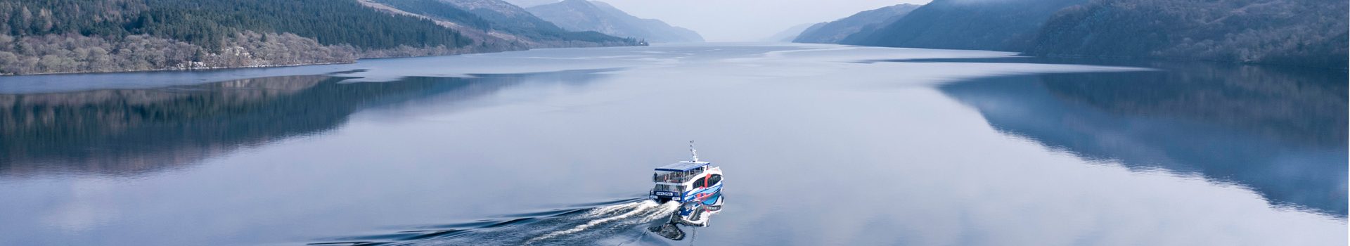 Cruise LA boat travelling across Loch Ness in Scotland