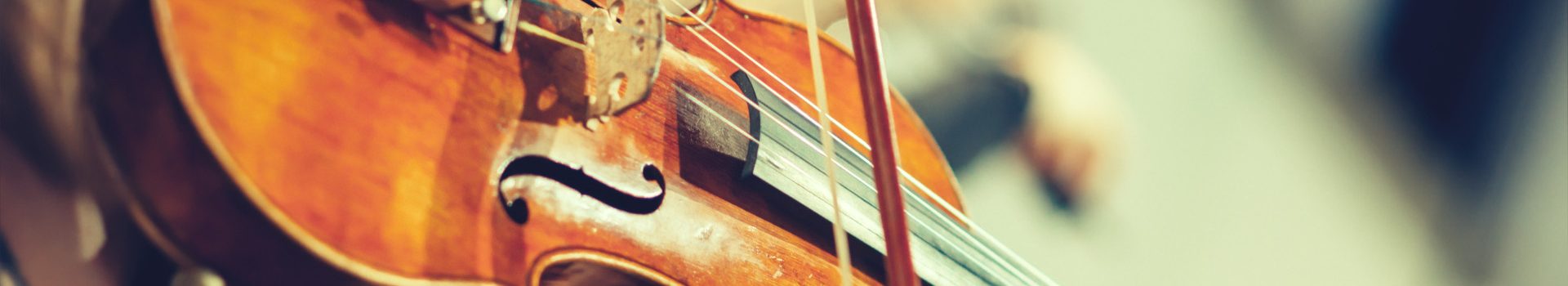 Close up of a violin being played on stage