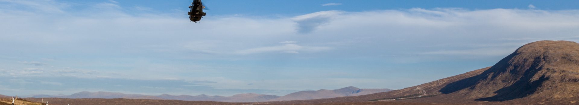 A helicopter flying over the Scottish Highlands