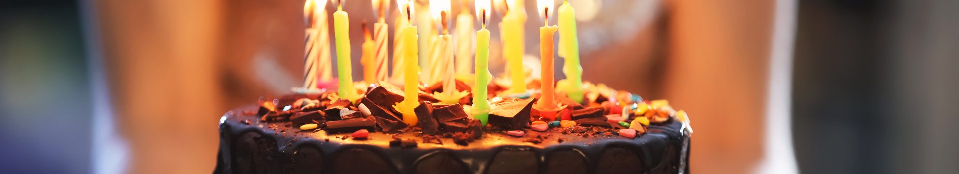 Chocolate birthday cake with lit candles