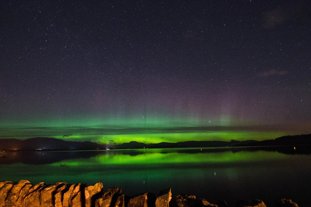 A view of the Northern Lights reflected in water