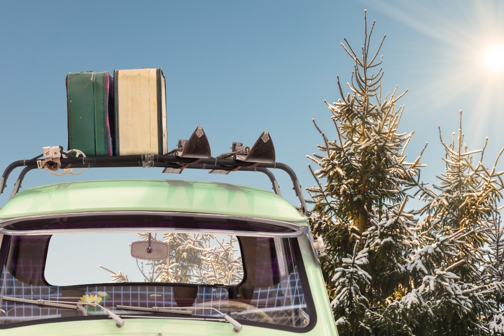 Larger version of Vintage car with suitcases on the roof