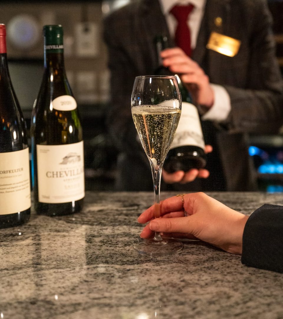 Glass of English sparkling wine during cool climate wine tasting at the Ness Walk bar with sommelier