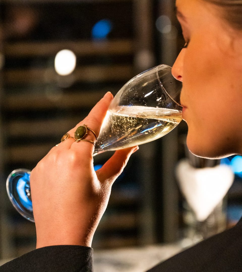 Lady sipping English Sparkling wine at a tasting at the Ness Walk bar
