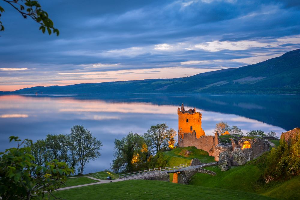 Ruins of Scotland Urquhart Castle at dusk on the shore of Loch Ness