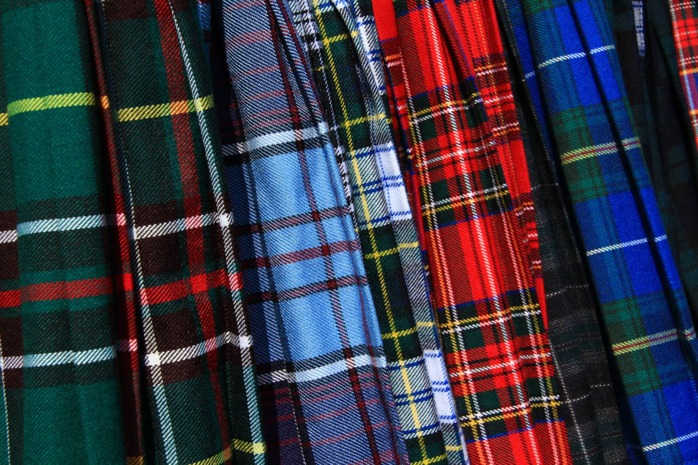 An assortment of colourful Scottish tartan kilts.