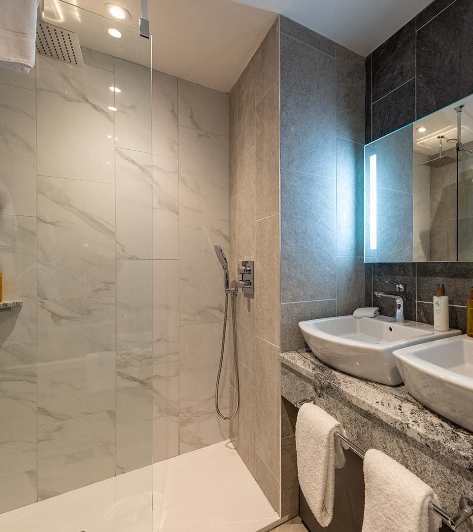 Our standard Ness Walk Hotel bathrooms. All with double sinks and large walk in rain showers. Our standard Ness Walk Hotel bathrooms. All with double sinks and large walk in rain showers.