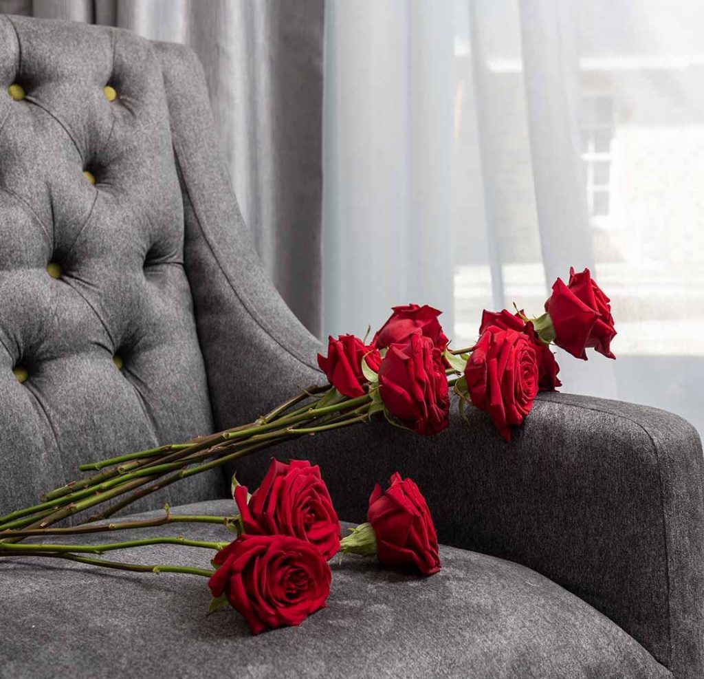 Roses laid out over a plush chair in a Ness Walk hotel bedroom
