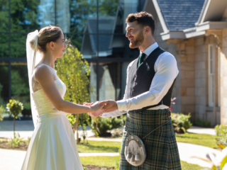 Bride and Groom looking at one another and holding hands