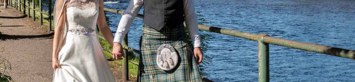 Wedding couple strolling on the banks of the River Ness