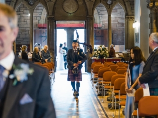 A piper pipes in a bride at Inverness Cathedral.