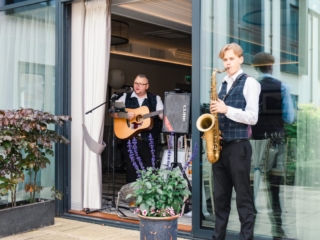 Wedding entertainers play music to Scottish wedding guests on the garden terrace at Ness Walk Hotel.