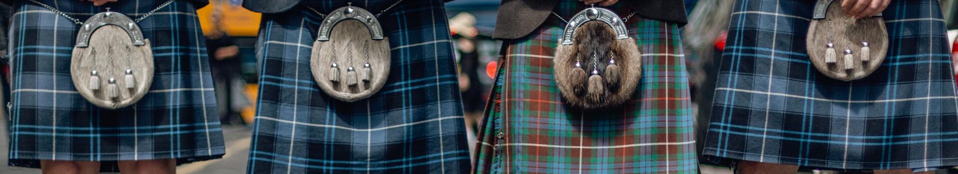 Men in kilts line up with sporrans.