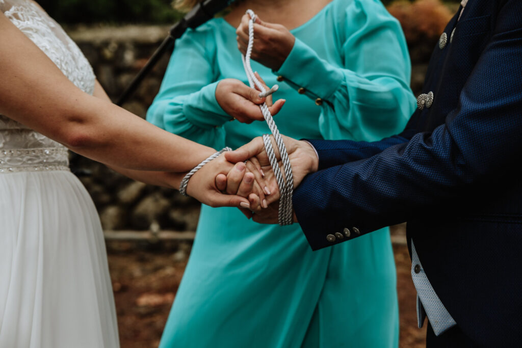 A celebrant tying the Bride and Grooms hands