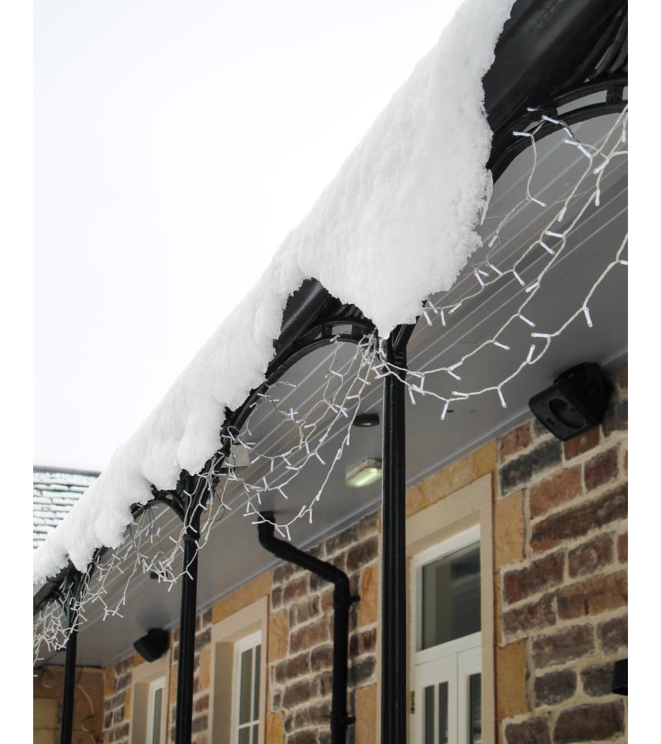 Fairy lights outside ness walk, closeup of roof with snow on top