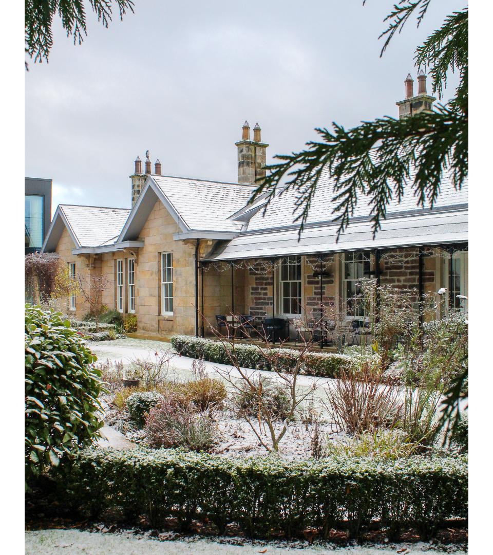 Ness Walk Hotel and front garden at Christmas with snow all around